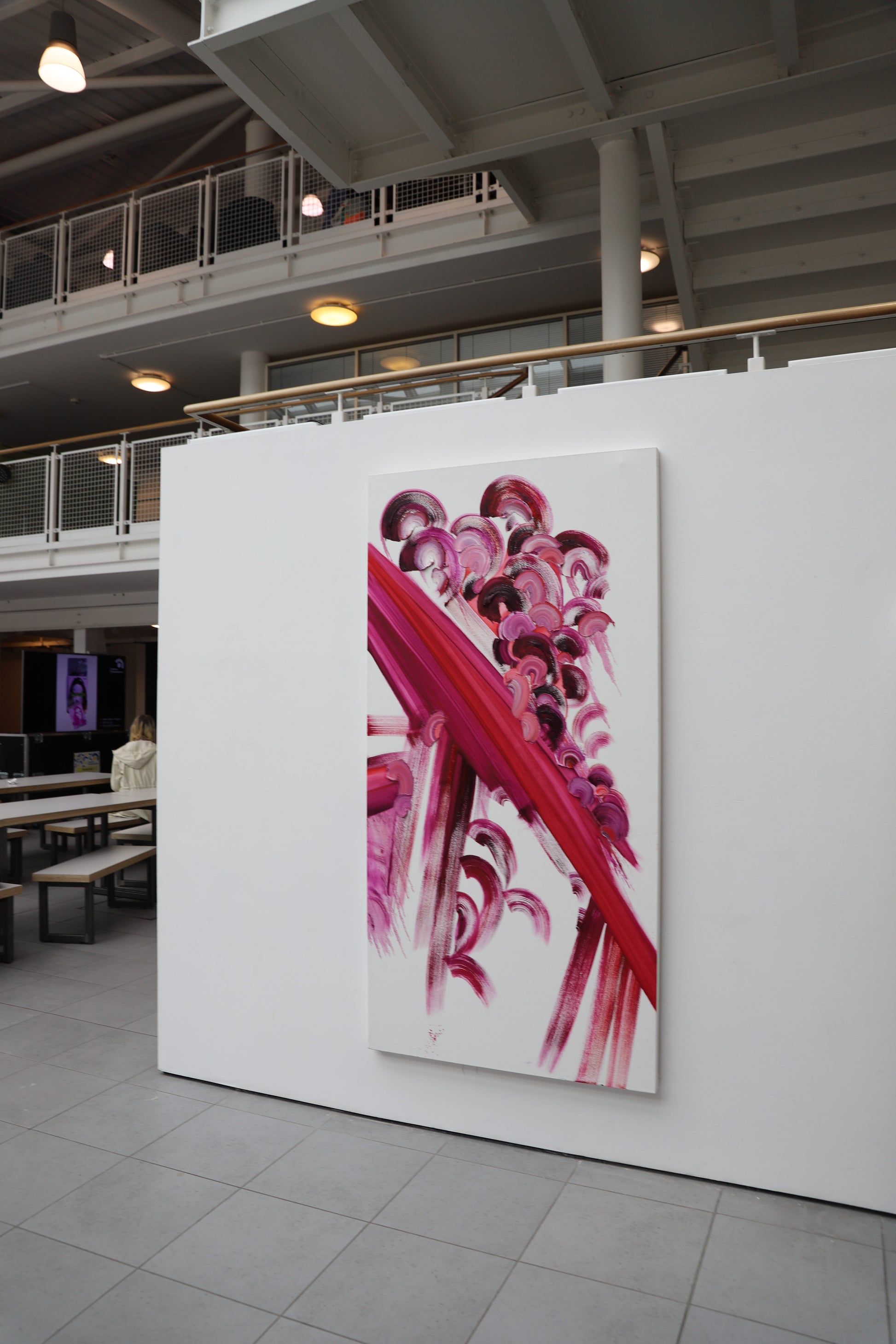 Abstract artwork on a white wall in an indoor setting