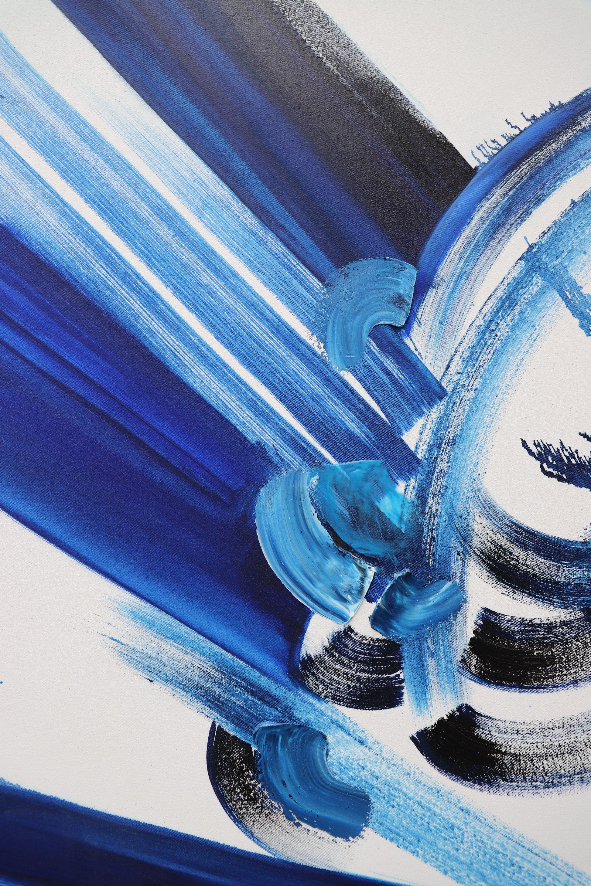 Details of abstract painting with blue and black brush strokes on a white background