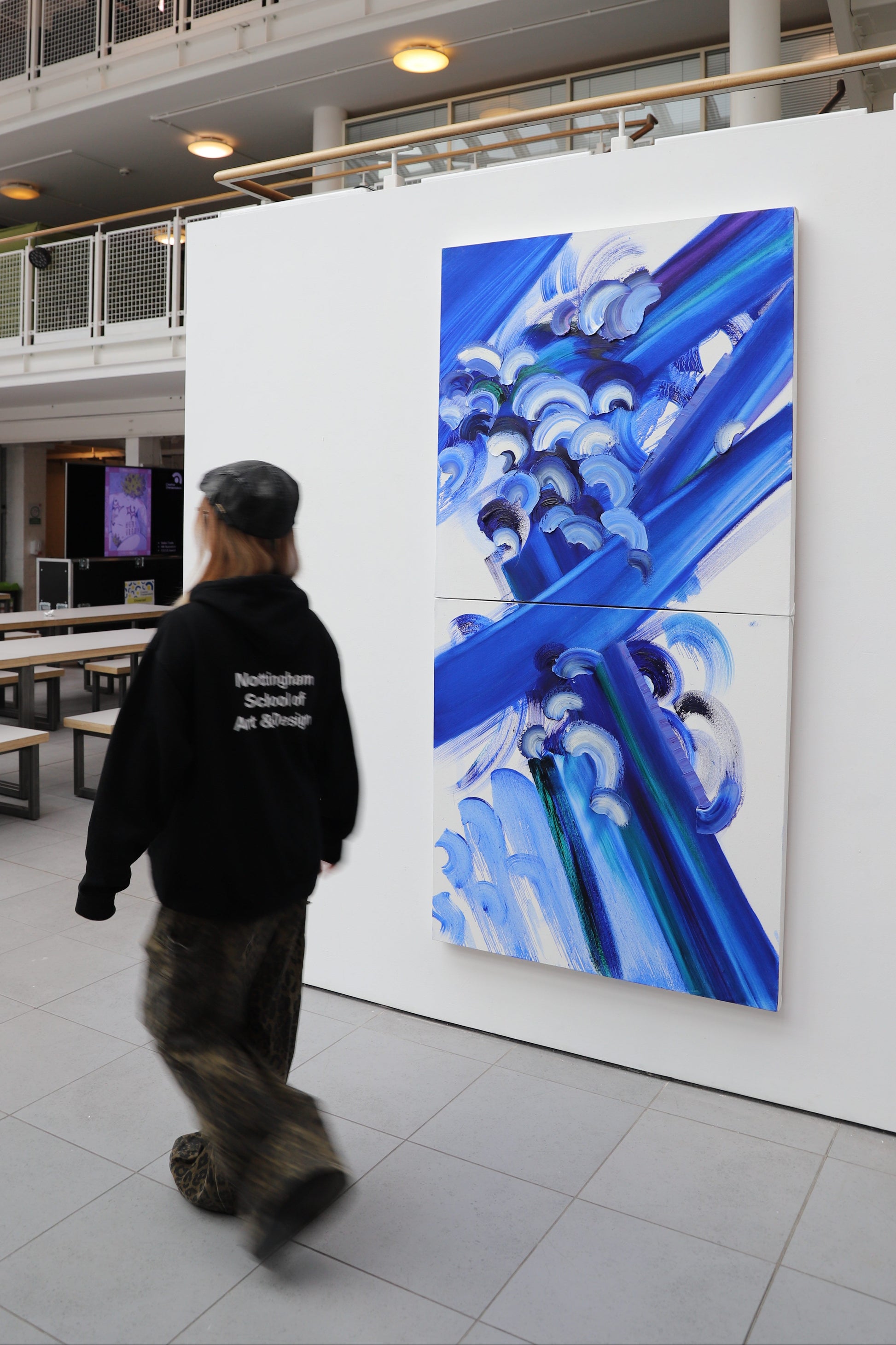 A large abstract painting with blue and white elements in the interior