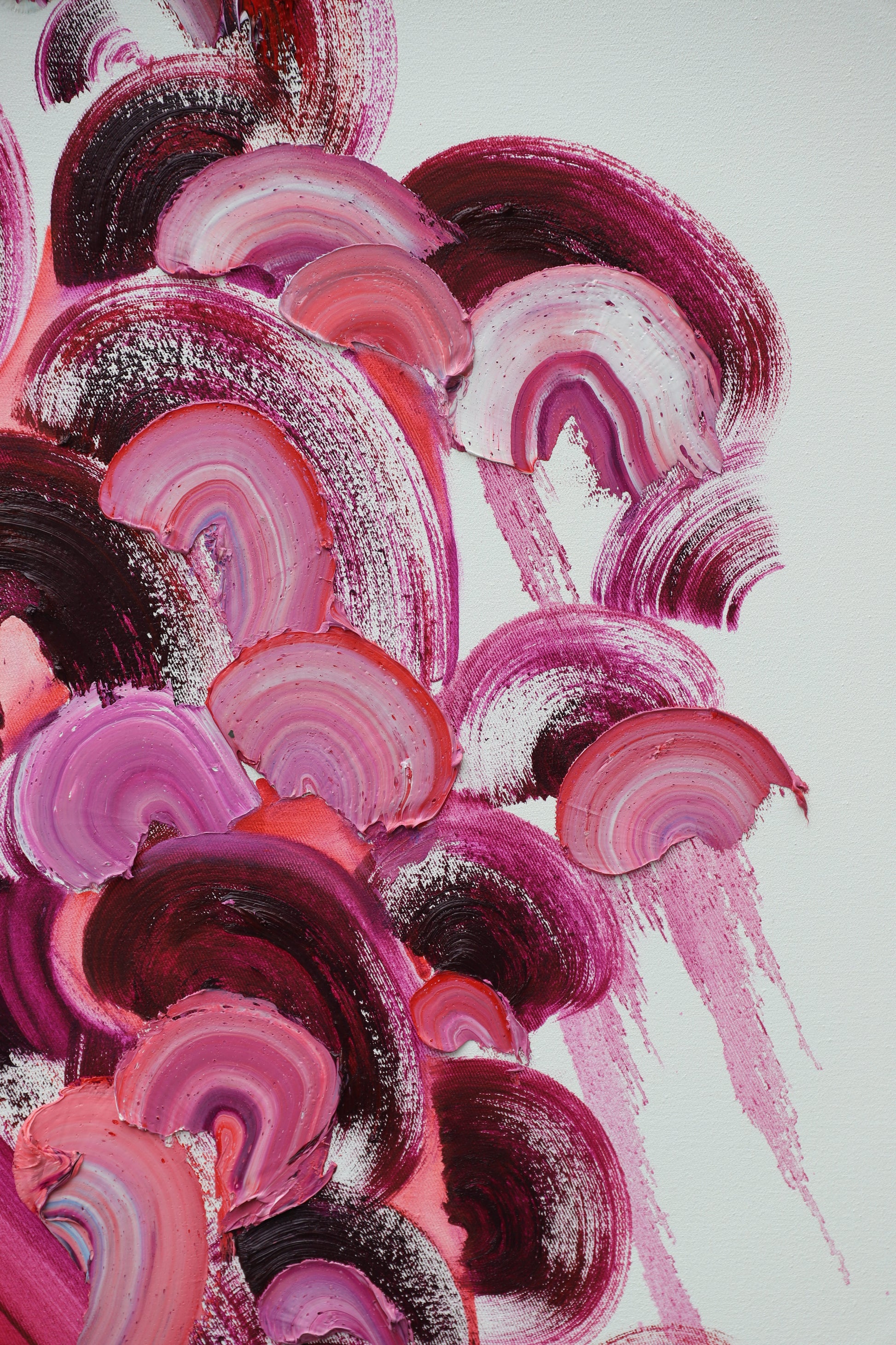 Abstract art with pink and purple circular patterns on a white background