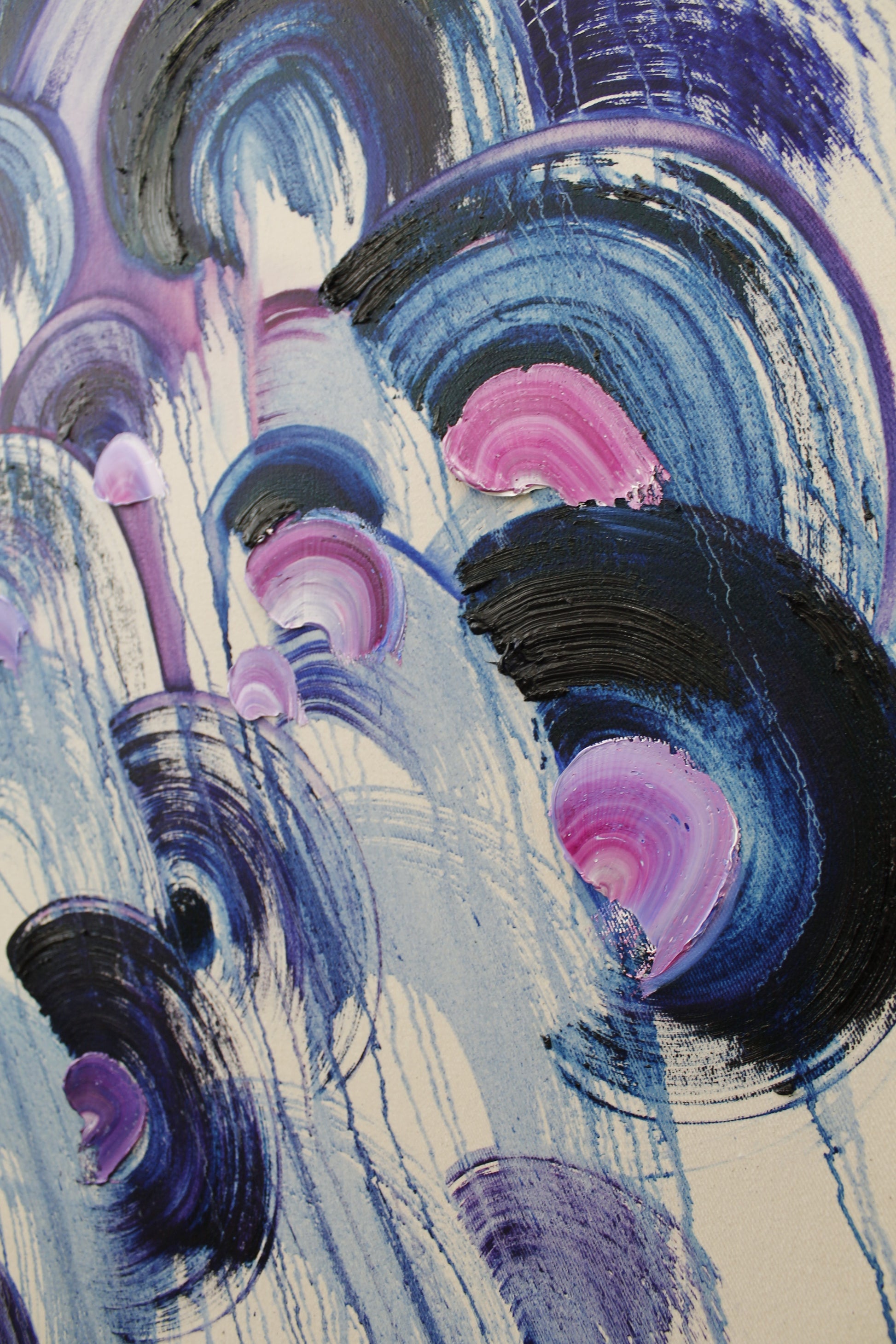 Abstract art with swirling blue, purple, and pink colors on a textured surface.